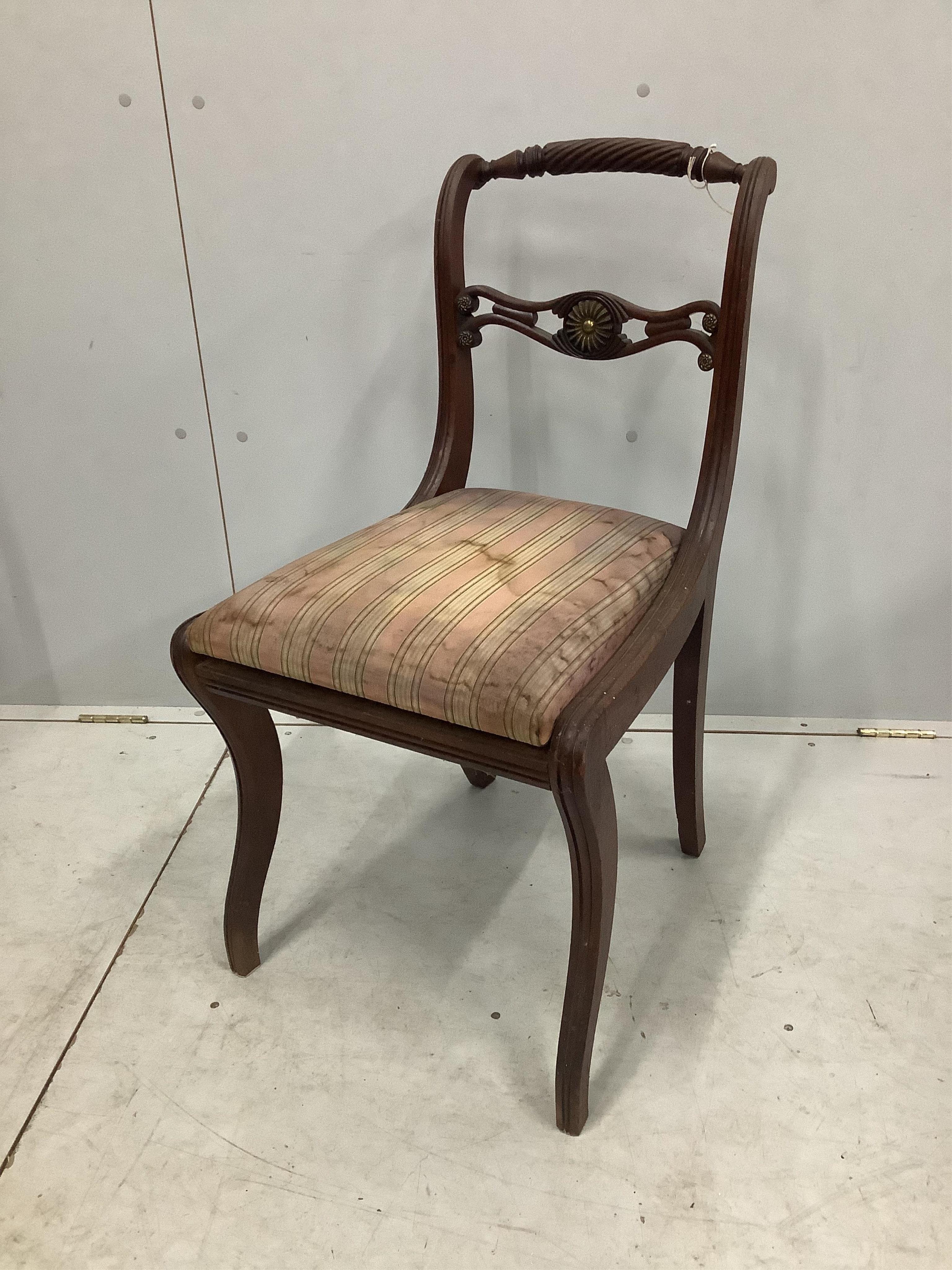 A set of eight Regency brass mounted mahogany dining chairs, one with arms. Condition - poor to fair, one lacking top rail